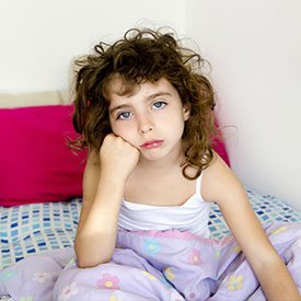 Unhappy child suffering from failed over-the-counter lice removal treatments by Lice Clinics of America - Columbus, OH